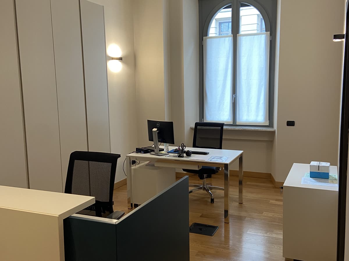 Stanza di lavoro con la finestra ad arco e il pavimento in rovere.